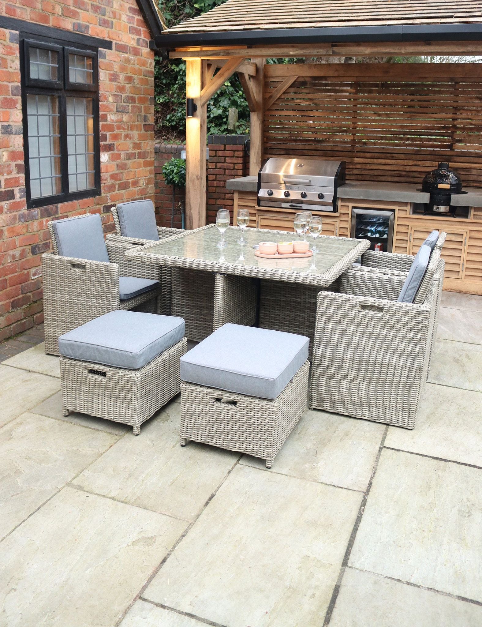 Image of Rattan dining set with six grey cushioned chairs and square table