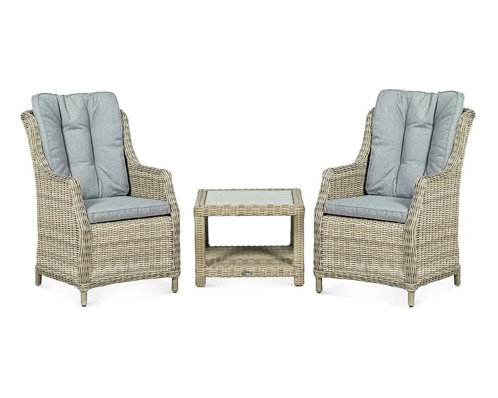 Image of Two wicker chairs with gray cushions and a matching table on a white background