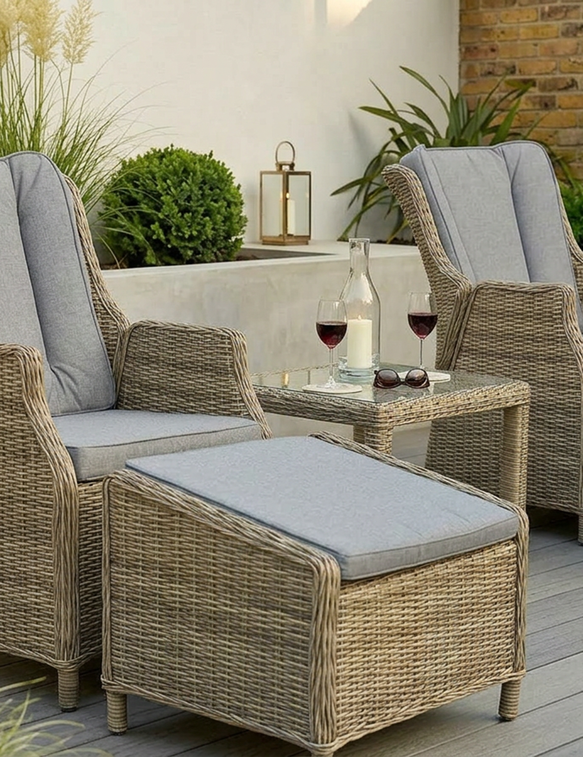 Image of Outdoor patio set with wicker chairs and ottoman on a wooden deck.