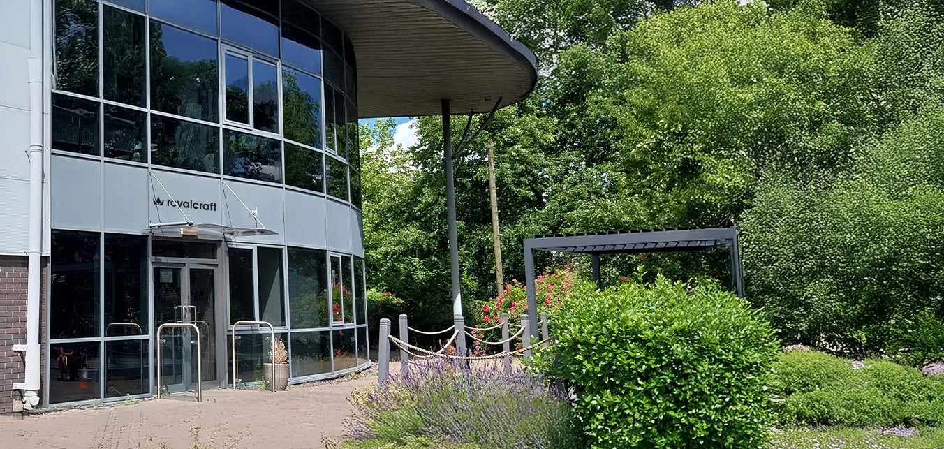 Image of Royalcraft showroom exterior with glass windows and garden view