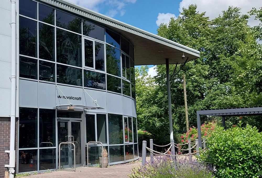 Image of Royalcraft showroom front with glass windows and landscaped greenery